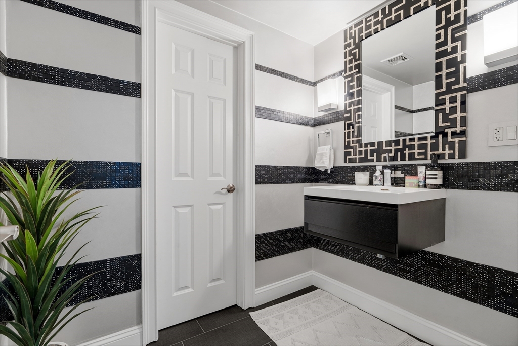 98 Waltham Street, Unit 1 Boston, MA 02118 - Photo 22 of 26 a bathroom with a double vanity sink and a mirror