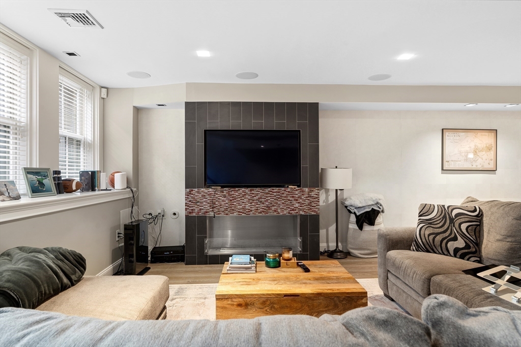 98 Waltham Street, Unit 1 Boston, MA 02118 - Photo 5 of 26 a living room with furniture and a fireplace