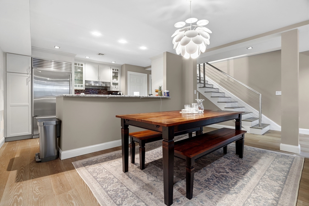 98 Waltham Street, Unit 1 Boston, MA 02118 - Photo 6 of 26 a view of dining room kitchen with stainless steel appliances granite countertop furniture and a rug