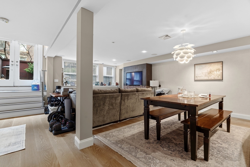 98 Waltham Street, Unit 1 Boston, MA 02118 - Photo 8 of 26 a room with a table chairs and a view of kitchen