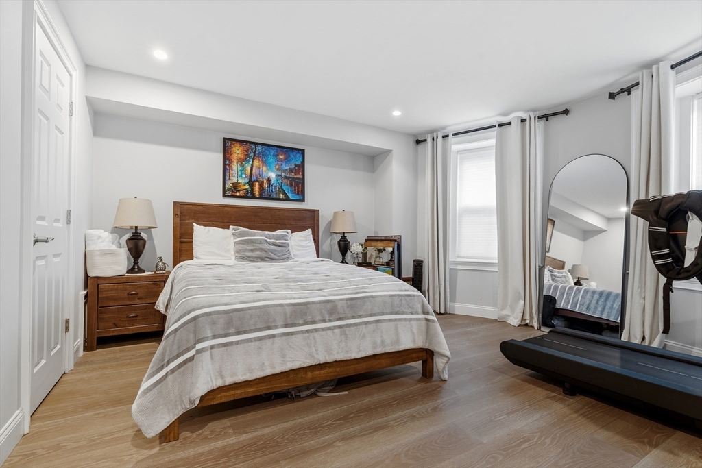 98 Waltham Street, Unit 1 Boston, MA 02118 - Photo 9 of 26 a bedroom with a bed and a mirror