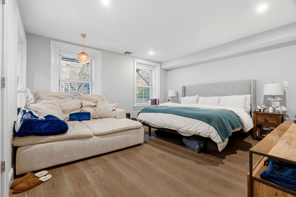 98 Waltham Street, Unit 1 Boston, MA 02118 - Photo 10 of 26 a spacious bedroom with a bed a window and couch