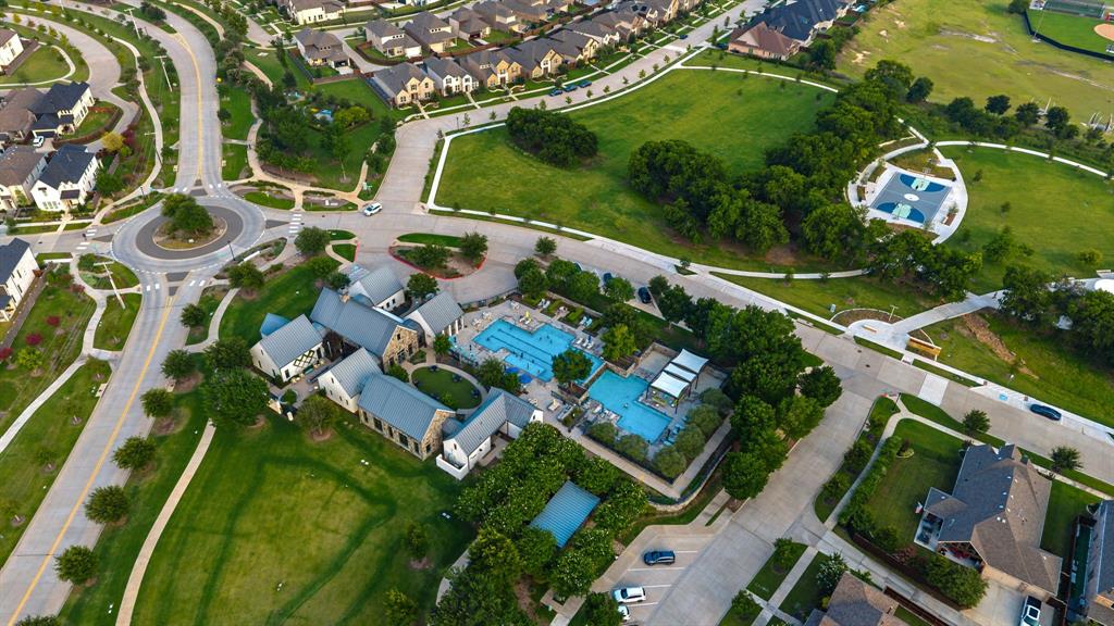 7852 Buffaloberry Road Frisco, TX 75035 - Photo 34 of 36 Aerial perspective highlighting a community hub with multiple pools, surrounded by green spaces and residential properties