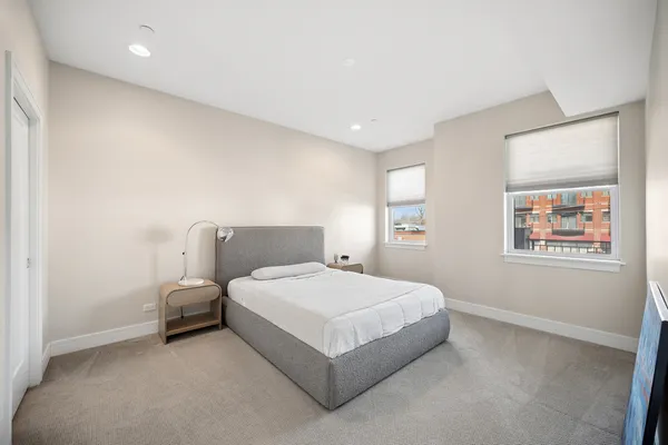a bedroom with a bed and a night stand