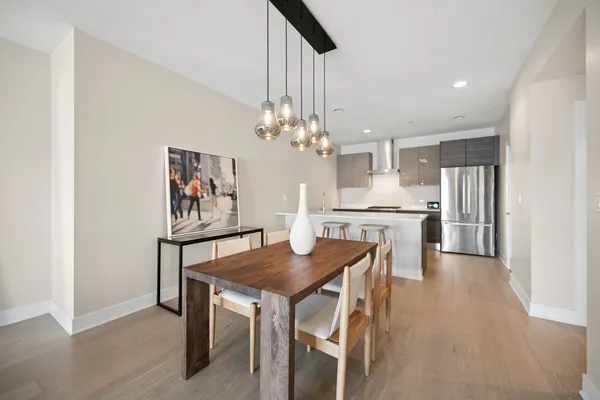 a view of a dining room with furniture and chandelier