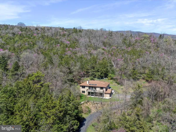 an aerial view of a house with mountain view