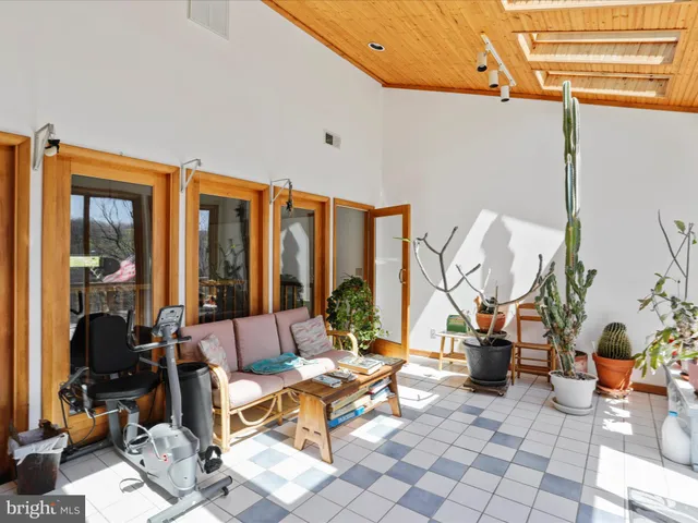 a living room with patio furniture and a large window