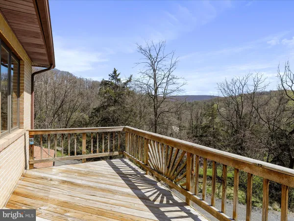 a view of balcony with wooden floor and fence