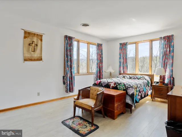 a bedroom with furniture and a large window