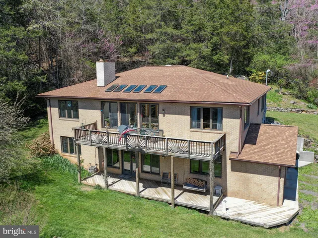 a view of a house with a yard porch and sitting area