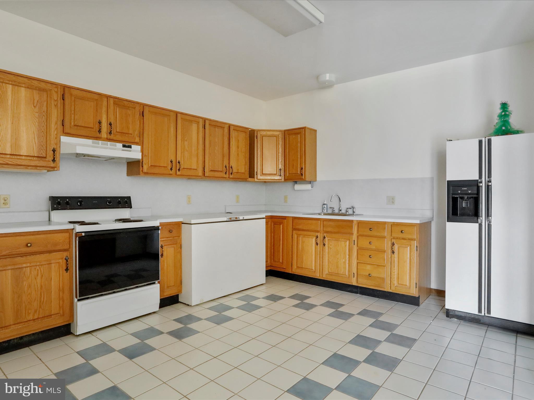 1639 Sugar Hill Road Maurertown, VA 22644 - Photo 31 of 57 a kitchen with stainless steel appliances granite countertop a stove a sink and a refrigerator