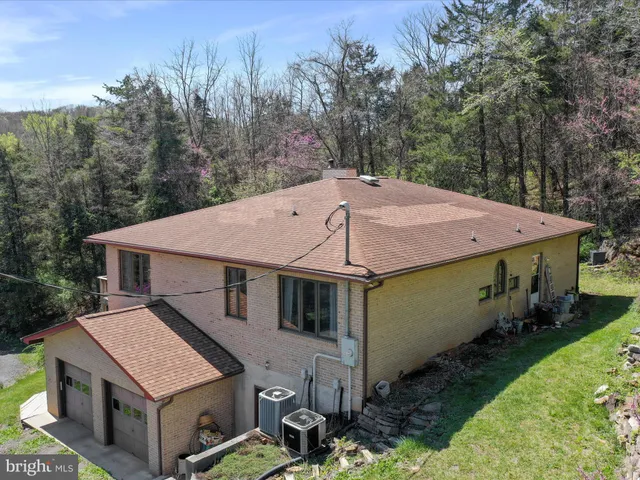 a aerial view of a house with a yard table and chairs