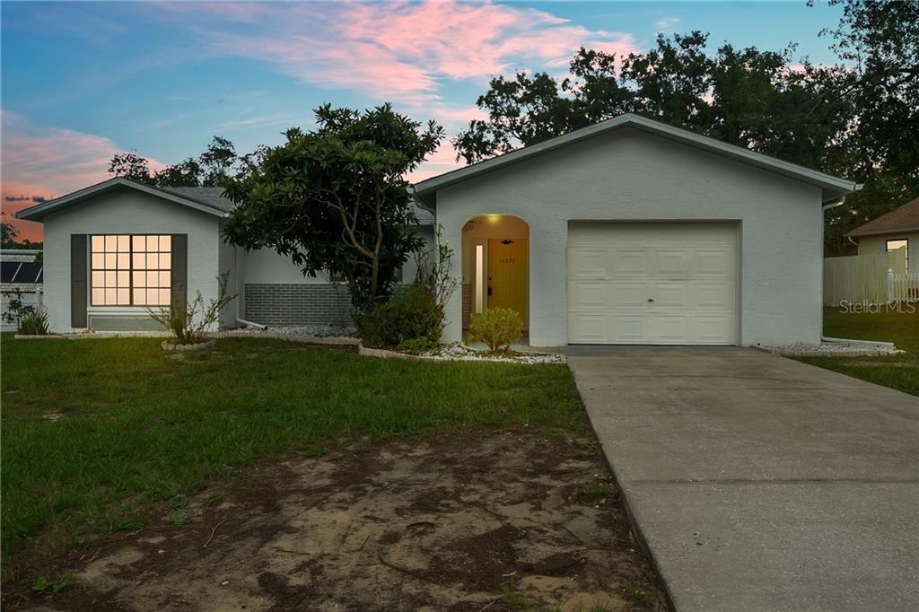11391 Terrell Road Spring Hill, FL 34608 - Photo 1 of 1 a front view of a house with a yard and garage