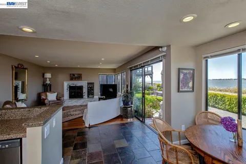 a bathroom with sinks a large mirror and a bathtub next to a window