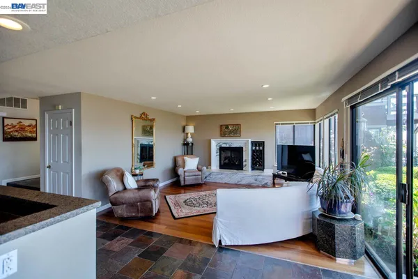 a living room with furniture and a floor to ceiling window
