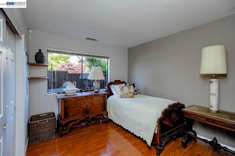 a view of a patio with chairs under an umbrella
