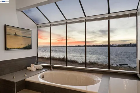 a bathroom with a tub and a large window