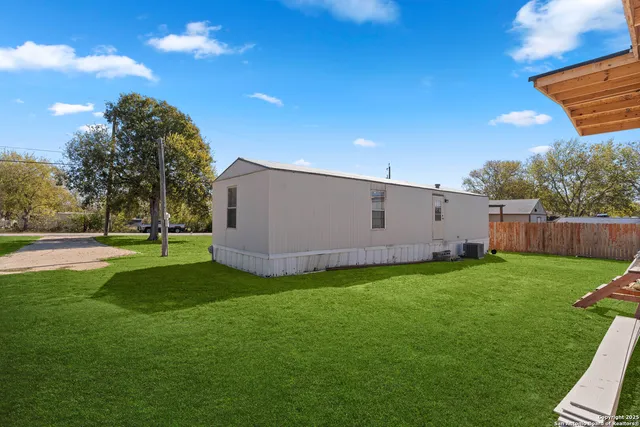 a view of a backyard with large trees