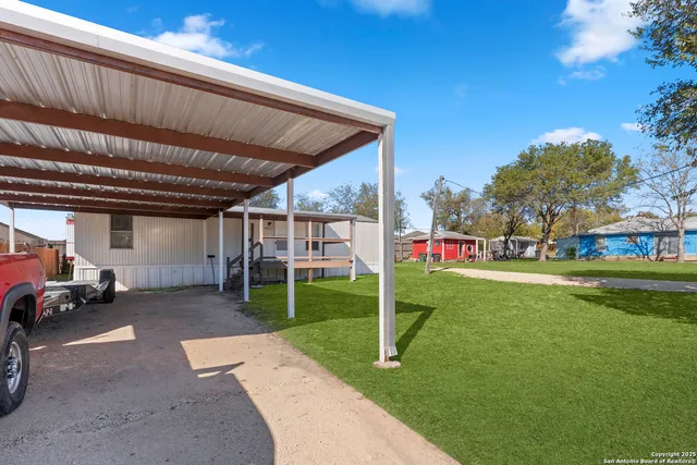 a view of a house with backyard and porch