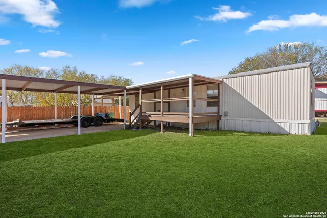 a view of a house with backyard and porch