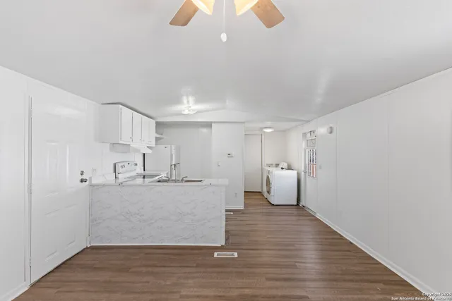 a view of a kitchen with wooden floor
