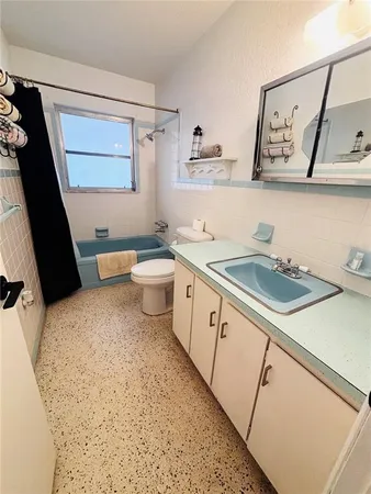 a bathroom with a sink a toilet and vanity