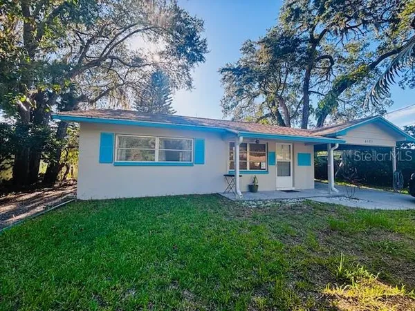 a front view of house with a garden and patio