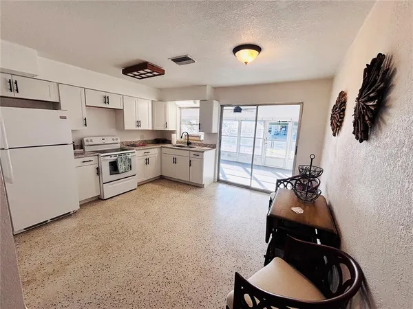 a kitchen with a sink appliances and cabinets