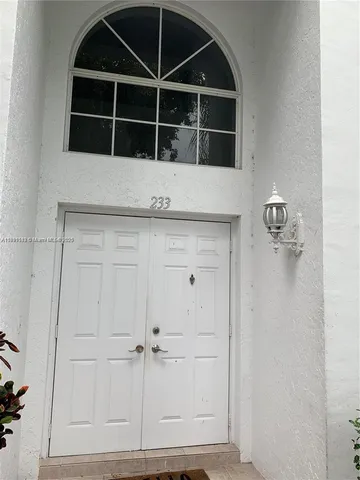 a view of staircase with railing and white walls