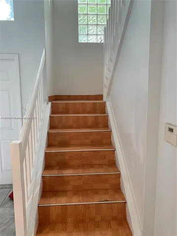 a white toilet sitting next to a sink