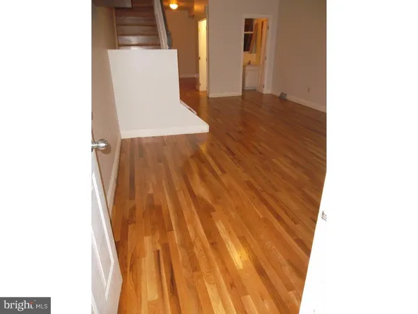 a view of a room with wooden floor