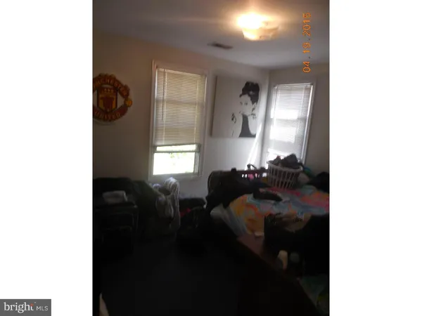 a living room with furniture and a mirror