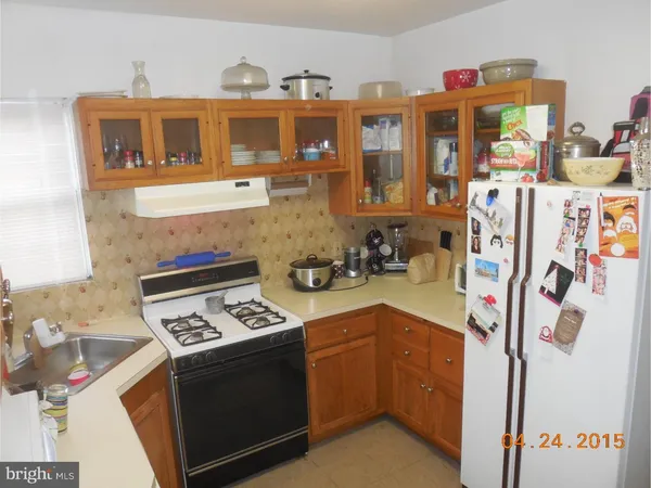 a kitchen with stainless steel appliances granite countertop a stove and a refrigerator
