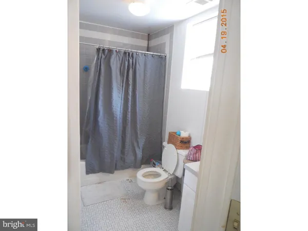 a white toilet sitting next to a bathroom sink