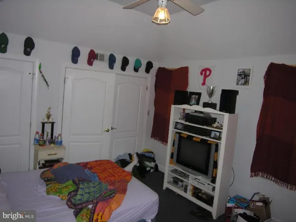 a bedroom with furniture and a flat screen tv