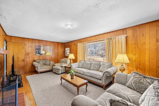 a view of a dining room with furniture wooden floor and chandelier