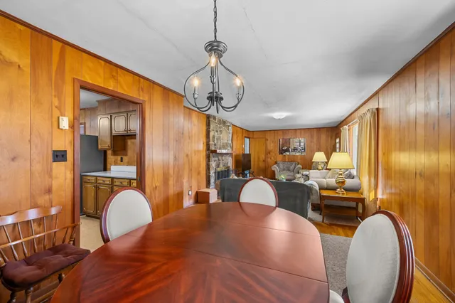 a dining room with furniture window and wooden floor
