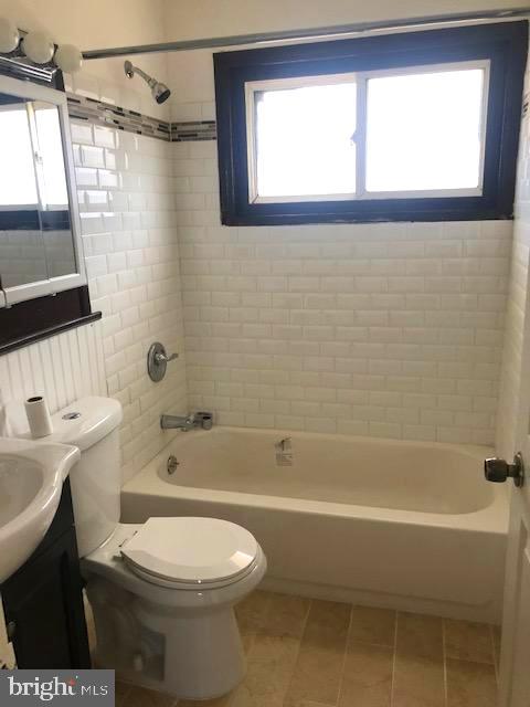 28 Violet Road Levittown, PA 19057 - Photo 13 of 16 a bathroom with a toilet a sink a mirror and a bathtub