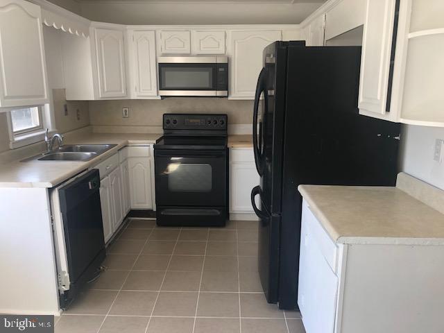 28 Violet Road Levittown, PA 19057 - Photo 4 of 16 a kitchen with a sink a stove and refrigerator