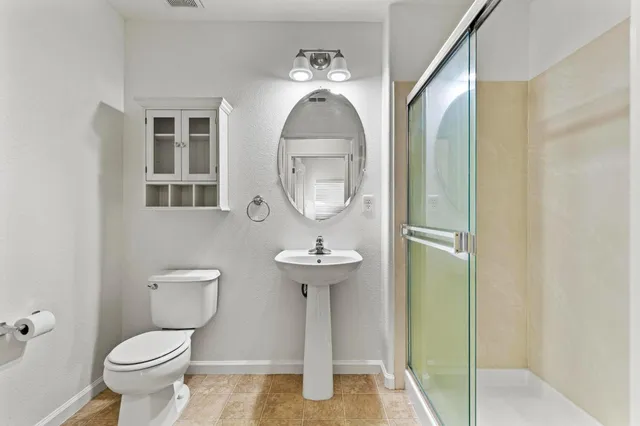 an empty room with chandelier fan