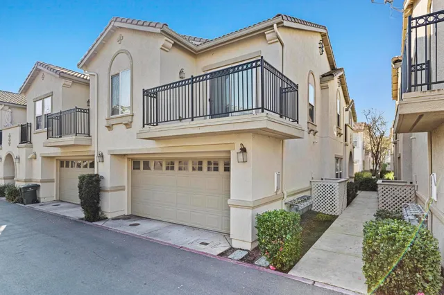 a view of a white building with many windows
