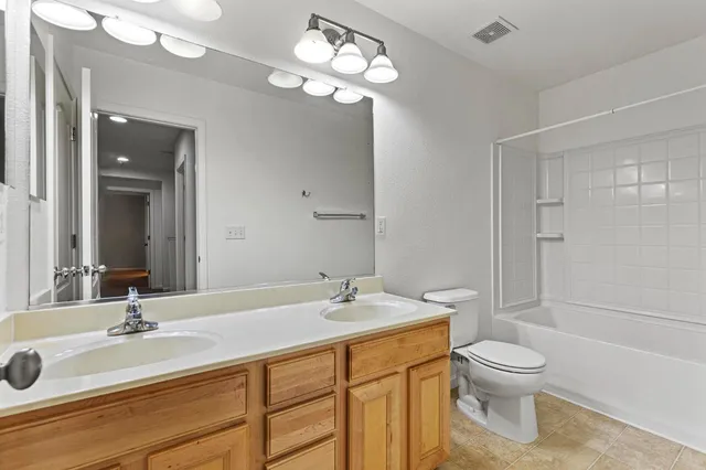 a bathroom with a sink vanity and a mirror