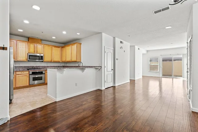 a kitchen with stainless steel appliances granite countertop a refrigerator stove and microwave