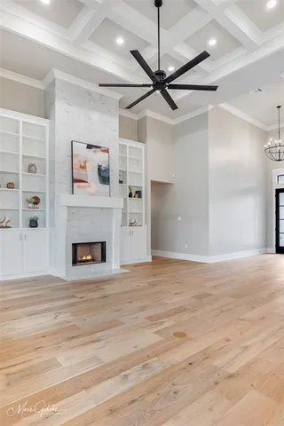 a view of an empty room with a fireplace and a window