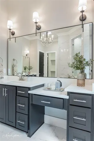 a bathroom with a sink vanity granite and a mirror