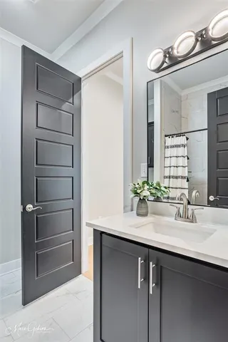 a bathroom with a double vanity sink and a mirror
