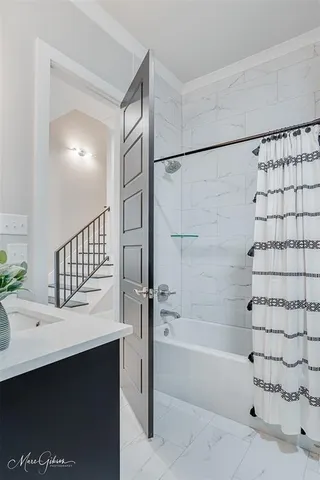 a bathroom with a bathtub and a sink