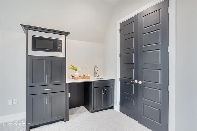 a kitchen with a refrigerator and cabinets