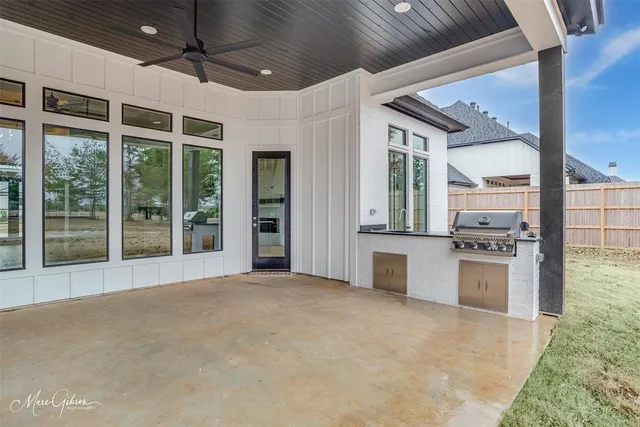 a large kitchen with stainless steel appliances granite countertop a stove and a large window