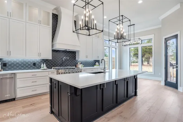 a kitchen with stainless steel appliances a sink stove and refrigerator